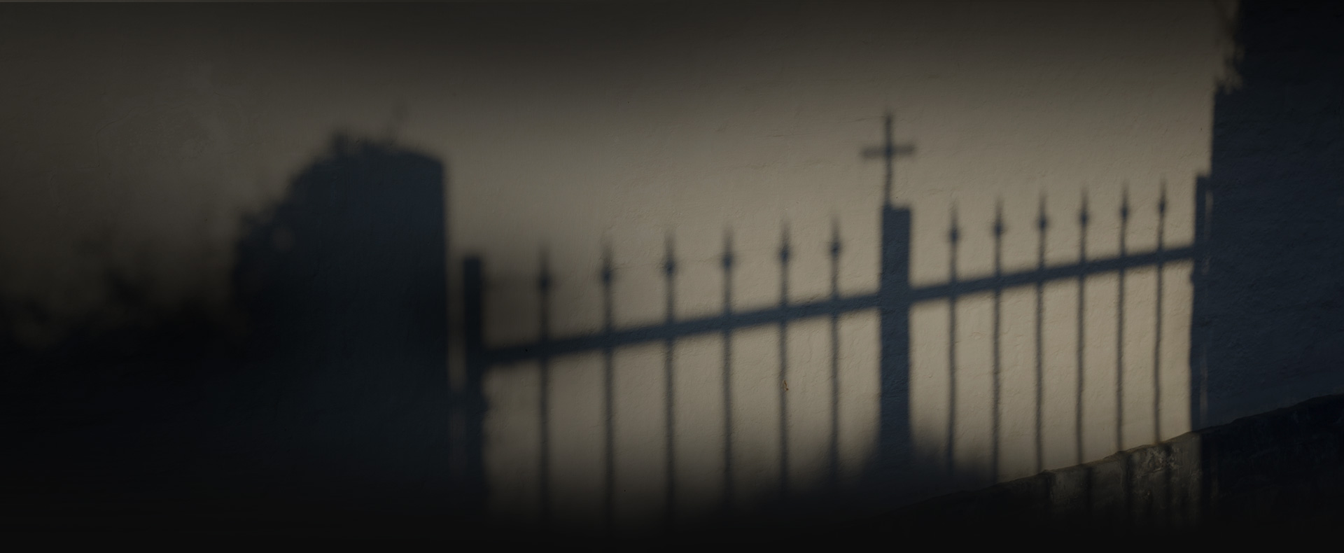 shadow of fence and Christian cross