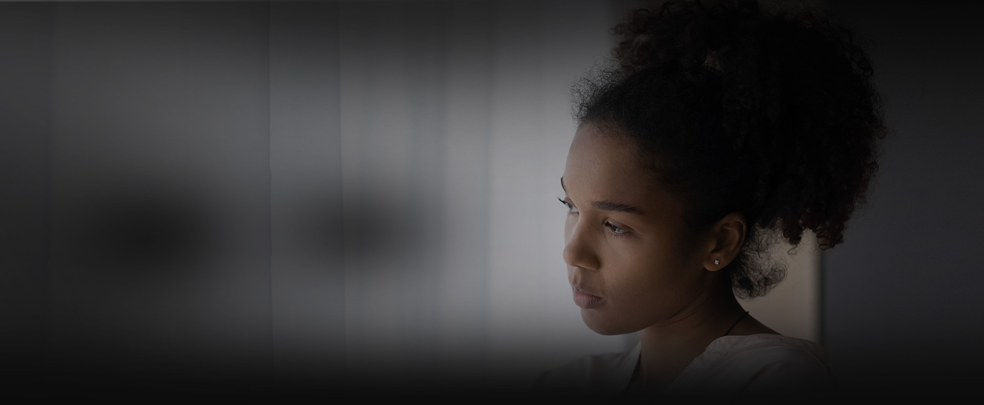 Woman looks out window