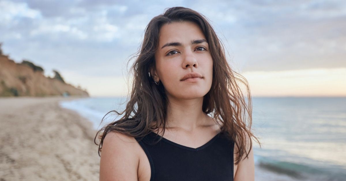 Woman standing near water at the beach