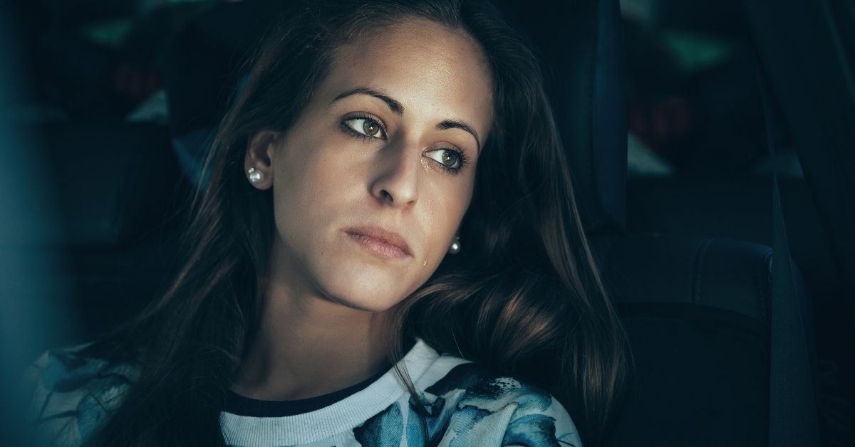 Woman in car staring out window