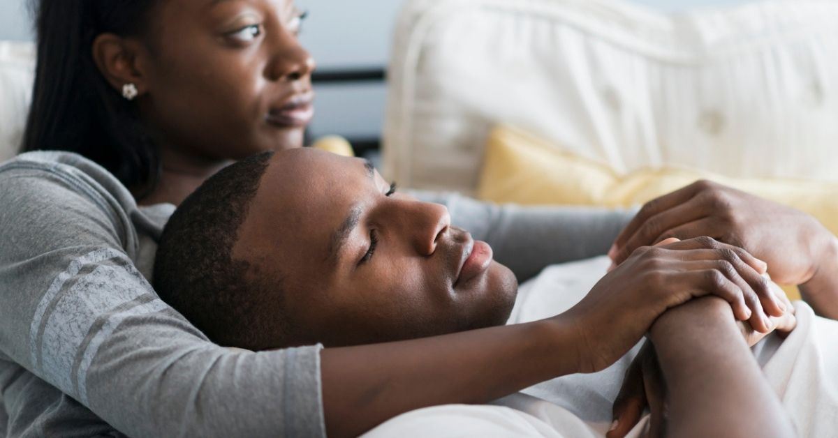 Man and woman laying on couch