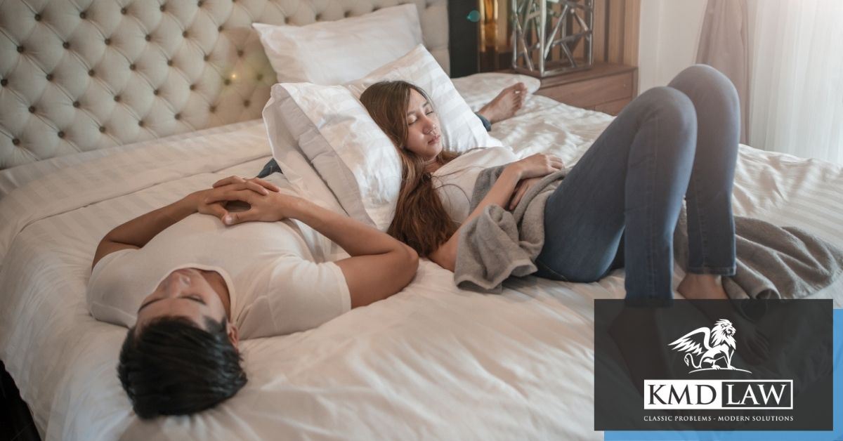 Man and woman laying on bed