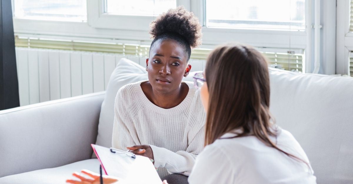 Woman on couch talking to therapist