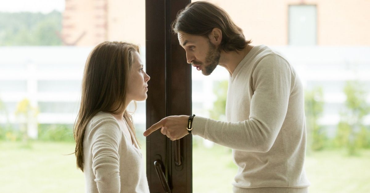 Upset man pointing at woman