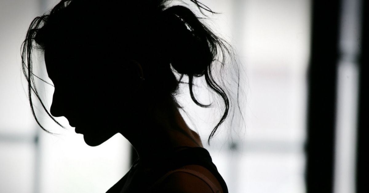 Silhouette of woman looking down