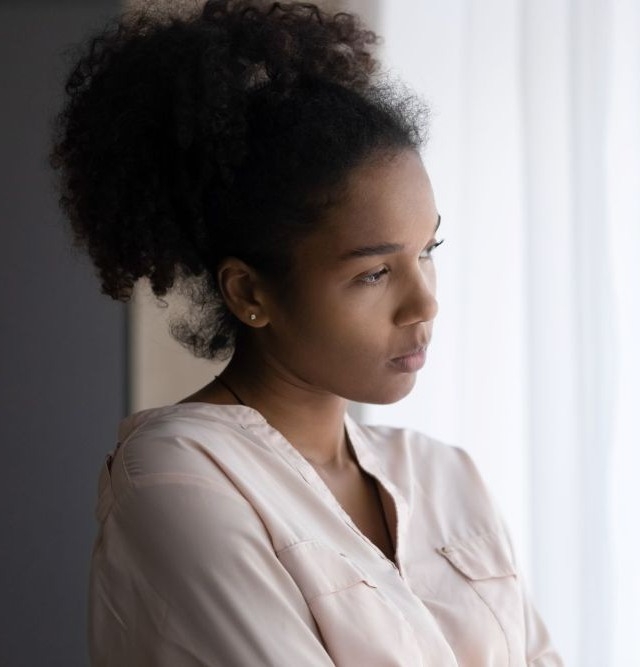 Woman looks out window