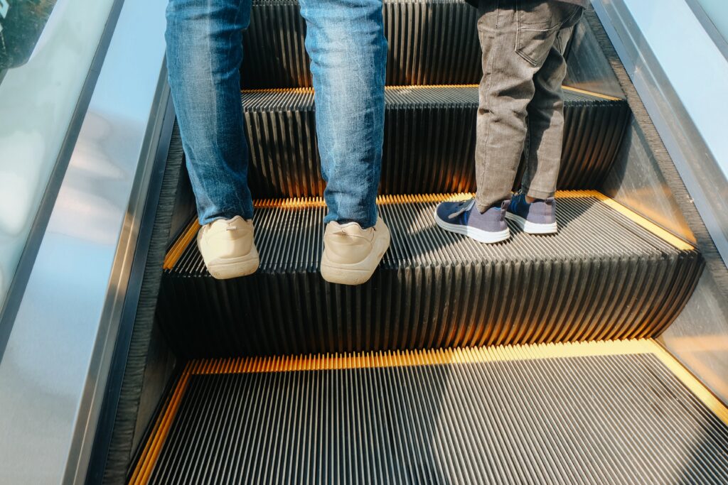 Parent and child on escalator