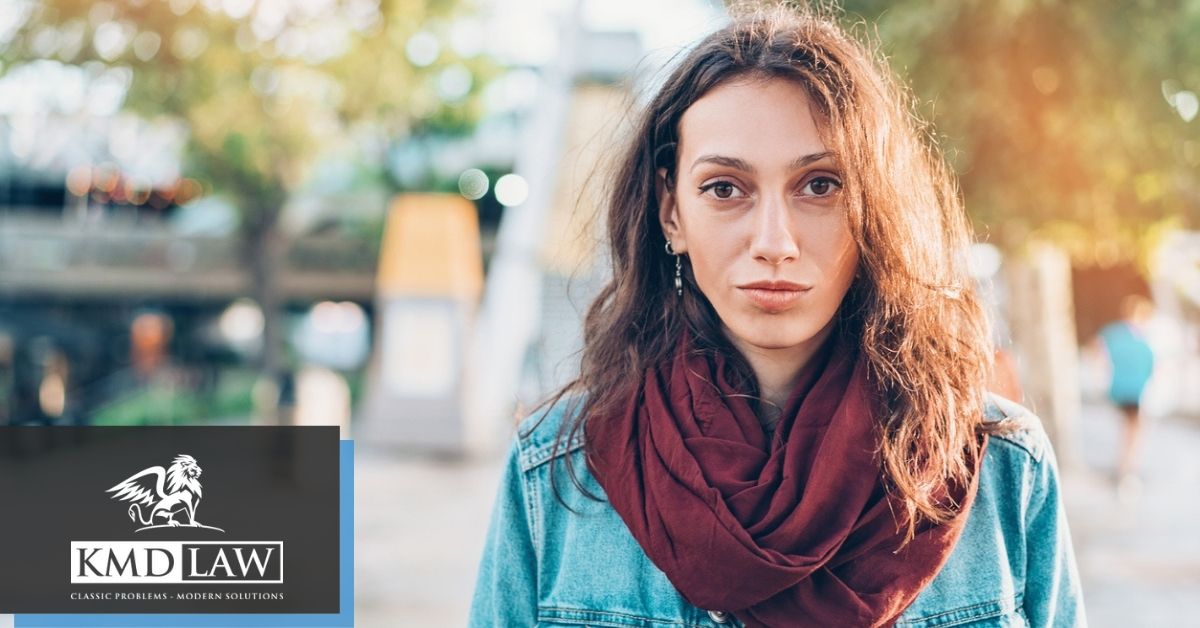 Woman in scarf and jacket looking forward