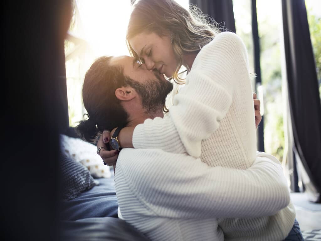Man hugging woman and kissing