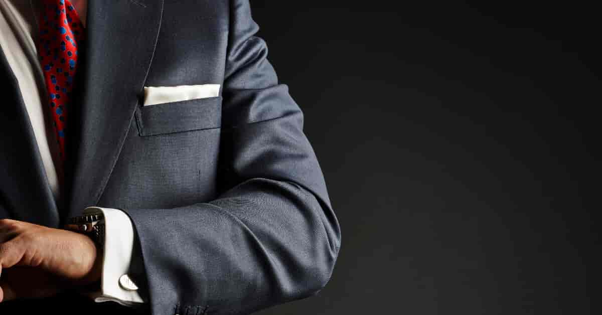 Man in suit looking at his watch