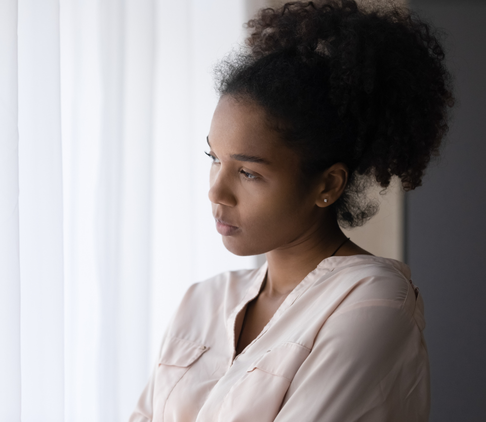 woman looks out window