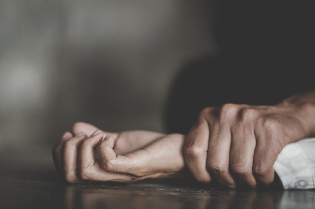 Hand grabbing wrist